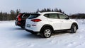 White and black suv car parked in a snowy field Royalty Free Stock Photo