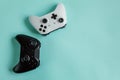 White and black two joystick gamepad, game console isolated on pastel blue colourful trendy background. Computer gaming Royalty Free Stock Photo