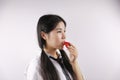 Close up white blank background Asian Chinese girl young woman is eating fruit Strawberry healthy balanced life Royalty Free Stock Photo