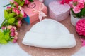 White blank beanie above a small round tablecloth hat surrounded by gift boxes and flower Royalty Free Stock Photo