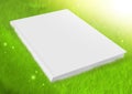 White blank book in green grass Royalty Free Stock Photo