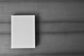 White blank book cover on table. Minimalist composition top view.