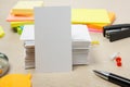 White blank business card. Office table desk with set of colorful supplies, cup, pen, pencils, flower, notes, cards on Royalty Free Stock Photo