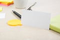 White blank business card. Office table desk with set of colorful supplies, cup, pen, pencils, flower, notes, cards on Royalty Free Stock Photo