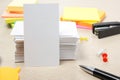 White blank business card. Office table desk with set of colorful supplies, cup, pen, pencils, flower, notes, cards on Royalty Free Stock Photo