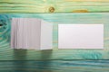 White blank business visit card, gift, ticket, pass, present close up on blurred blue background. Copy space Royalty Free Stock Photo