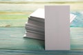 White blank business visit card, gift, ticket, pass, present close up on blurred blue background. Copy space Royalty Free Stock Photo