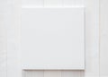 White blank canvas mockup square size on white wood wall for arts painting and photo hanging Royalty Free Stock Photo