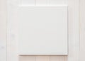 White blank canvas mockup square size on white wood wall for arts painting and photo hanging decoration Royalty Free Stock Photo