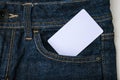 A white blank card in a dark blue jeans pocket for text, copy space Royalty Free Stock Photo