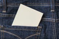 A white blank card in a dark blue jeans pocket for text, copy space Royalty Free Stock Photo