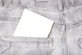 A white blank card in a dark gray worn jeans pocket for text, copy space Royalty Free Stock Photo