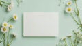 White Blank Card Mockup With Daisies Flowers in Decoration Against A Green Background. Spring Greeting Card Mockup Template Royalty Free Stock Photo