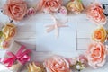 White blank card with a pink ribbon, gift box and rose flowers o Royalty Free Stock Photo