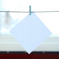 White blank card on rope, window glass background. Creative remi Royalty Free Stock Photo