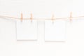 White blank cards on rope, light wall background Royalty Free Stock Photo