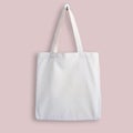 White blank cotton eco tote bag, design mockup. Shopping bag hanging on wall Royalty Free Stock Photo