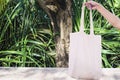 White blank cotton eco tote . Design mockup. holding blank canvas tote bag Royalty Free Stock Photo