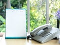 White blank desktop flip-top calendar template vertical style near the phone on wooden desk. Royalty Free Stock Photo