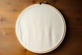 White blank embroidery hoop on wooden table top