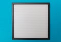 White blank empty board with black frame, blue wall background, copy space Royalty Free Stock Photo