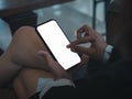 White blank mobile smart phone screen holding by businessperson who using finger touch and pinch for zoom in or zoom out. Royalty Free Stock Photo