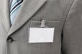 White blank name tag is attached to chest of a businessman . Royalty Free Stock Photo