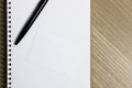 A white blank notebook with black pen on a wooden table. Royalty Free Stock Photo
