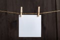 White blank notes hanging with clothespins on rope on wooden background. Copy space, mockup. Space for your text Royalty Free Stock Photo