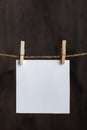 White blank notes hanging with clothespins on rope on wooden background. Copy space. Space for your text. Vertical frame Royalty Free Stock Photo