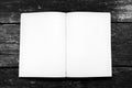 White, blank opened book pages on aged old weathered wooden background