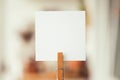 White blank paper in clothspin, close up, copy space Royalty Free Stock Photo