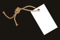 White, Blank Paper Price Tag Or Label On A Beautiful Twisted Cord, Isolated On A Black Background