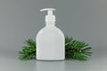 white blank perfume dispenser bottle with pine tree branch