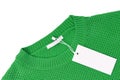 White blank rectangular clothing tag on green knitted sweater isolated on white background Royalty Free Stock Photo