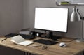 White blank screen monitor on the wooden table,tablet for drawing and designing,opened notebook and pen,mouse,lamp against white w Royalty Free Stock Photo