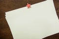 White Blank Sheets of Paper with Star Shape Clipper on Brown Wood Background. New Year`s Resolutions Plans. Letter to Santa Clause