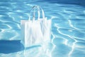 White blank shopping bag inside a pool, use as mockup or template Royalty Free Stock Photo