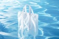 White blank shopping bag inside a pool, use as mockup or template Royalty Free Stock Photo