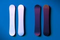 White Blank Snowboard Near Dark Violet And Blue Blank Snowboard on Blue Background. 3d Rendering.