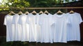 White blank t-shirts hanging on a clothesline. Laundry or dry clean concept. Generative AI