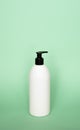 White blank unbranded cosmetic plastic bottle with black dispenser pump for shampoo, gel, lotion, cream, bath foam. Royalty Free Stock Photo