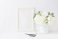 White blank wooden frame mockup. Wedding table still life composition with floral bouquet made of peony and Gypsophila Royalty Free Stock Photo