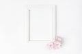 White blank wooden picture frame mockup with pink Japanese cherry blossoms lying on the white table. Poster product Royalty Free Stock Photo