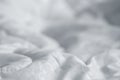 White blanket. Wrinkle messy blanket in bedroom after waking up in the morning. Bed details. Royalty Free Stock Photo