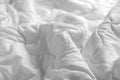 White blanket. Wrinkle messy blanket in bedroom after waking up in the morning. Bed details. Royalty Free Stock Photo