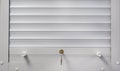 White blinds with a lock on the window. Royalty Free Stock Photo