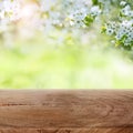 White blossoms in a garden with wooden table