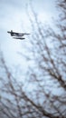 White and blue airplane soaring in the air during overcast weather