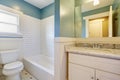 White and blue bathroom witth marble-topped vanity.